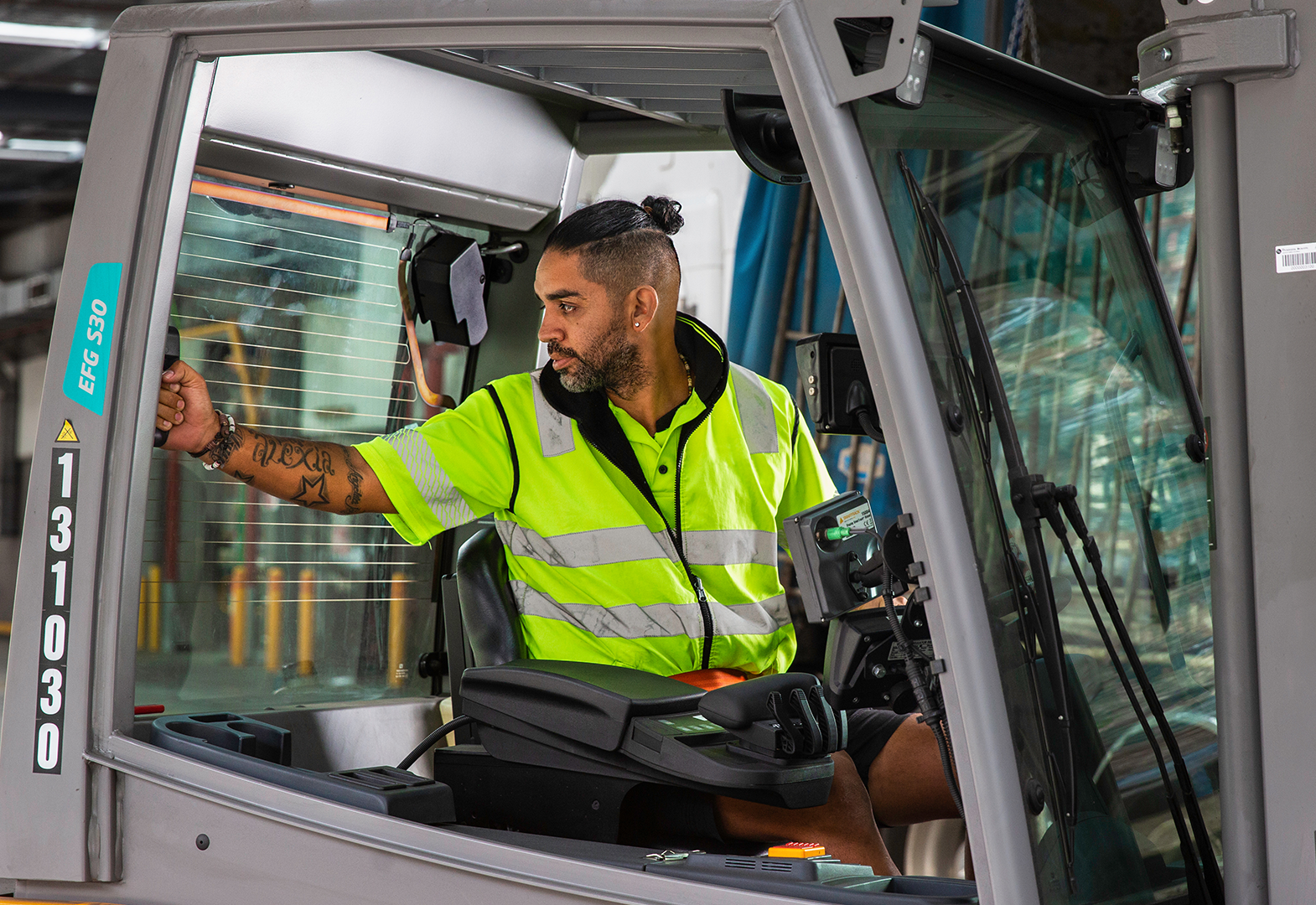 man operating forklift inside a warehouse